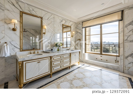 Elegant marble bathroom with natural light and golden fixtures in upscale residence 129372091