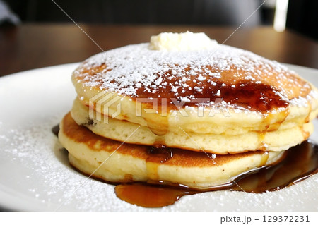 Delicious stacked pancakes with butter and syrup on a white plate ready for breakfast 129372231