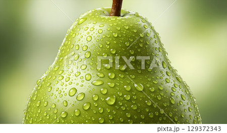 Freshness and health: Close-up of a green pear covered in dewdrops showcasing natural beauty and healthy eating 129372343