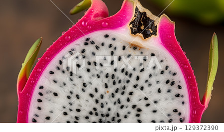 Close-up slice of vibrant dragon fruit showcasing its unique texture and vibrant color, perfect for creative projects Close-up slice of vibrant dragon fruit showcasing its unique texture and vibrant color, perfect for creative projects 129372390