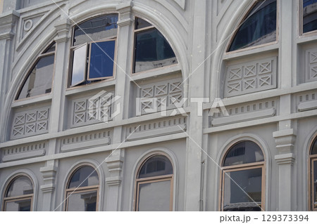 Detailed view of windows, doors and balconies of city buildings  129373394