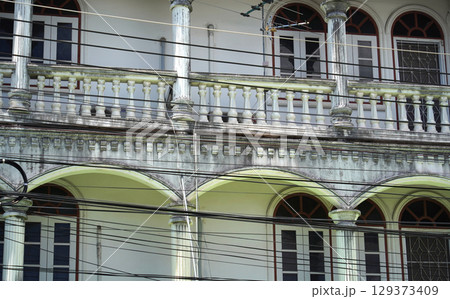 Detailed view of windows, doors and balconies of city buildings  129373409
