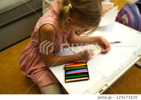 A mother supports her daughter with homework A mother supports her daughter with homework 129373820