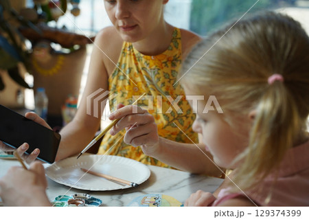 A young mother and her daughter enjoy a creative art session at home A young mother and her daughter enjoy a creative art session at home 129374399