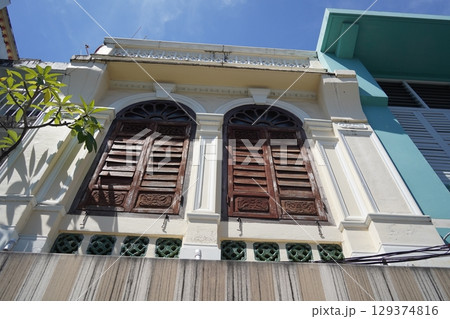 Detailed view of windows, doors and balconies of city buildings  129374816