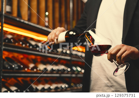 Red Wine Stream Mid-Pour in Wine Cellar 129375731