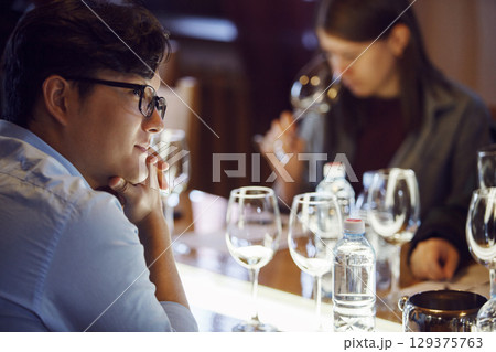 Attentive Sommelier Studying During Wine Tasting Session at Educational Workshop 129375763