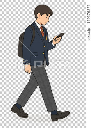 A high school boy walking home while looking at his smartphone 129376873