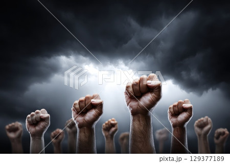 Wide Angle Image of Diverse People Raising Fists Against Dark Dramatic Stormy Sky in Unity Wide Angle Image of Diverse People Raising Fists Against Dark Dramatic Stormy Sky in Unity 129377189