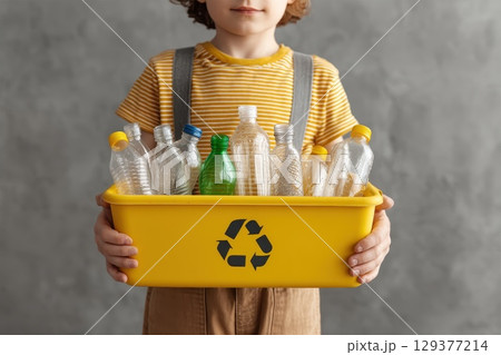 Child Holding Overflowing Recycling Bin with Plastic Bottles for Eco-Friendly Awareness Child Holding Overflowing Recycling Bin with Plastic Bottles for Eco-Friendly Awareness 129377214
