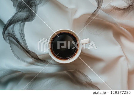 Aerial View of a Black Coffee Cup Surrounded by Abstract Steam Lines on Soft White Fabric Aerial View of a Black Coffee Cup Surrounded by Abstract Steam Lines on Soft White Fabric 129377280