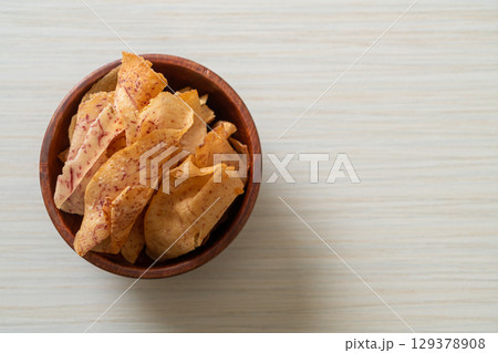 Taro Chips - fried or baked sliced taro 129378908