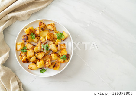Roasted or grilled potatoes on plate Roasted or grilled potatoes on plate 129378909