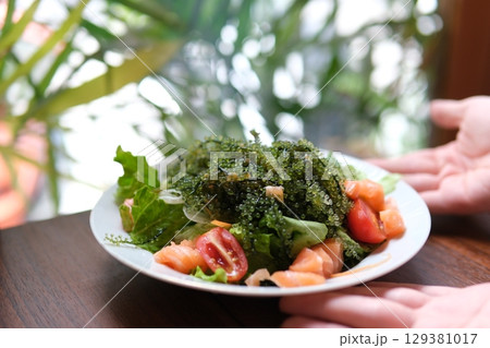 Caulerpa fresh green sea grape on wooden. plate of asian salad delicious in a restaurant beautiful presentation luxury delicacy Caulerpa fresh green sea grape on wooden. plate of asian salad delicious in a restaurant beautiful presentation luxury delicacy 129381017