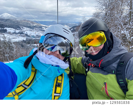 Skiers Taking Selfie on Snowy Mountain 129381838