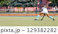 Female athlete passing the ball over the field. 129382282