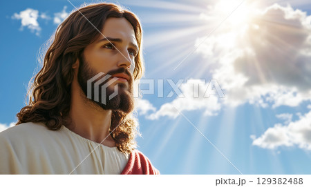 Portrait of Jesus with radiant sunlight illuminating his face against a clear sky 129382488
