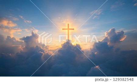A glowing cross rises above the clouds, symbolizing resurrection and divine hope at sunset A glowing cross rises above the clouds, symbolizing resurrection and divine hope at sunset 129382548