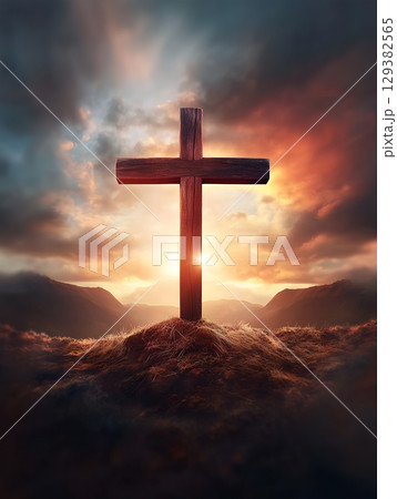 Crucifix symbol on a mountain at sunset with dramatic clouds and warm light in the background Crucifix symbol on a mountain at sunset with dramatic clouds and warm light in the background 129382565