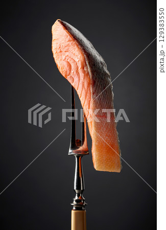 Smocked salmon on a black background. Smocked salmon on a black background. 129383550