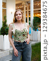 Beautiful slim blonde poses in boho wedding dresses and an embroidered corset on a summer terrace 129384675