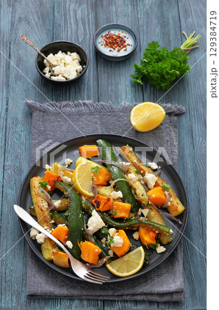 roasted vegetable salad with goat cheese on plate 129384719