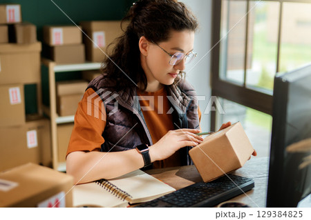 Woman working in a warehouse 129384825