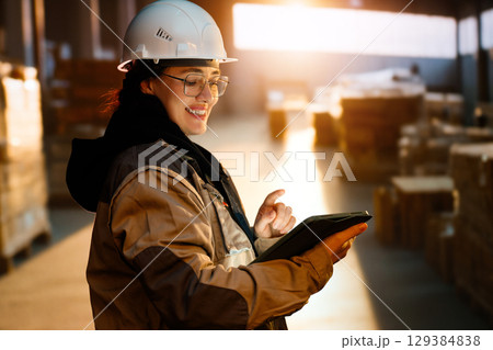 Young woman is working in warehouse 129384838