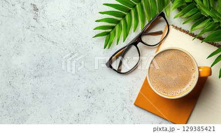 Cozy Coffee Break with Glasses and Notebook Surrounded by Greenery Cozy Coffee Break with Glasses and Notebook Surrounded by Greenery 129385421