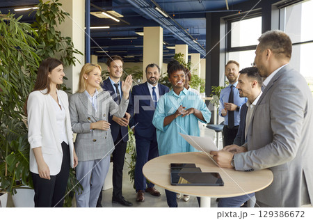 Group of business people in conference center lobby discussing issue 129386672