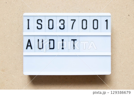 Lightbox with word ISO 37001 audit on wood background Lightbox with word ISO 37001 audit on wood background 129386679