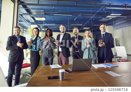 Business Team Applauding And Celebrating Success In Office Meeting Business Team Applauding And Celebrating Success In Office Meeting 129386718