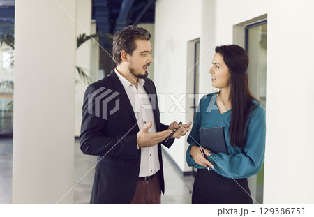 Colleagues Engaged In Discussion Together In Office Colleagues Engaged In Discussion Together In Office 129386751