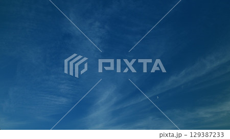 An Exquisite and Majestic Beautiful Blue Sky Filled with Wispy Clouds Calmly Presenting at Dusk Time An Exquisite and Majestic Beautiful Blue Sky Filled with Wispy Clouds Calmly Presenting at Dusk Time 129387233