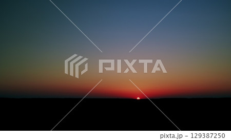 The Serene Sunset with Vibrant Gradients is Beautiful Over a Wondrous Horizon and Beyond The Serene Sunset with Vibrant Gradients is Beautiful Over a Wondrous Horizon and Beyond 129387250