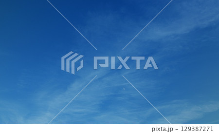 Serene blue skies adorned with wispy clouds provide a calming aesthetic for all Serene blue skies adorned with wispy clouds provide a calming aesthetic for all 129387271