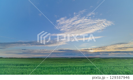 A Tranquil Landscape at Dusk Featuring an Expansive Sky Filled with Vibrant Colors A Tranquil Landscape at Dusk Featuring an Expansive Sky Filled with Vibrant Colors 129387946