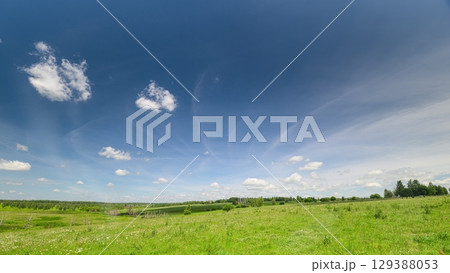 A Vibrant Green Landscape Set Against a Clear Blue Sky, Perfect for a Picturesque Day A Vibrant Green Landscape Set Against a Clear Blue Sky, Perfect for a Picturesque Day 129388053