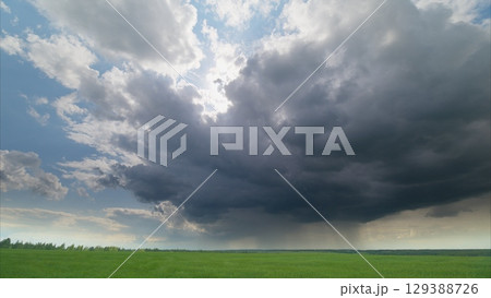 A Dramatic and Captivating Cloudscape Displaying Beautiful Views Over Lush Green Fields A Dramatic and Captivating Cloudscape Displaying Beautiful Views Over Lush Green Fields 129388726