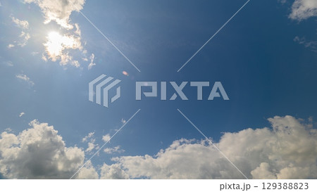 A beautiful and picturesque cloudy sky adorned with sunlight streaming through the clouds A beautiful and picturesque cloudy sky adorned with sunlight streaming through the clouds 129388823