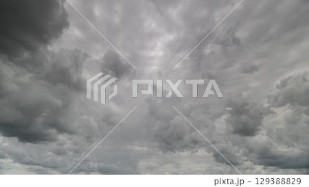 A breathtakingly dramatic cloudy sky adorned with dynamic and mesmerizing patterns A breathtakingly dramatic cloudy sky adorned with dynamic and mesmerizing patterns 129388829