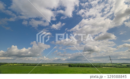 A Serene Cloudy Sky Over Beautiful Green Fields That Captivates the Human Imagination Delightfully A Serene Cloudy Sky Over Beautiful Green Fields That Captivates the Human Imagination Delightfully 129388845