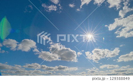 Experience the Stunning Sky Views with a Bright Warm Sun in a Sea of Fluffy White Clouds 129388849