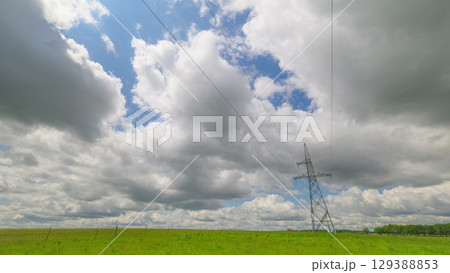 High voltage power transmission tower and electricity pylon with wires against blue sky. Power pole. High voltage power transmission tower and electricity pylon with wires against blue sky. Power pole. 129388853
