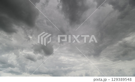 A Dramatic Gray Cloudy Sky with Intricate Swirling Patterns Creating a Striking Visual 129389548