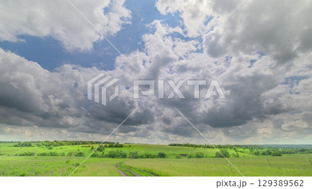 The Beautiful Sky Spreads Over a Lush, Green Landscape, Creating a Stunning Scene The Beautiful Sky Spreads Over a Lush, Green Landscape, Creating a Stunning Scene 129389562