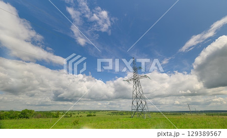 High voltage transmission tower or power tower and electrical distribution substation during day. Electricity pylon. High voltage transmission tower or power tower and electrical distribution substation during day. Electricity pylon. 129389567