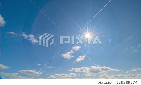 A Beautiful Sky adorned with a brilliant Sun and fluffy Clouds during a perfect day A Beautiful Sky adorned with a brilliant Sun and fluffy Clouds during a perfect day 129389574