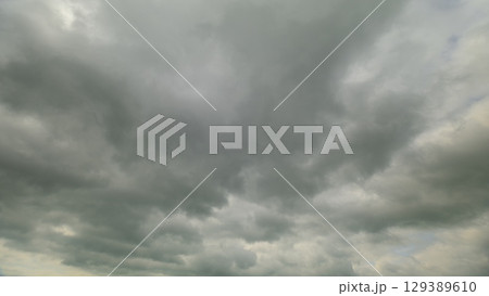 Dramatic Overcast Skies Featuring Fluffy Clouds in a Beautiful Contrast with the Horizon 129389610