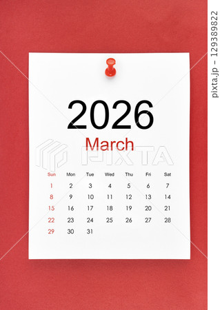 March 2026 calendar page with push pin on red color background. March 2026 calendar page with push pin on red color background. 129389822